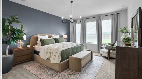Interior primary bedroom with windows