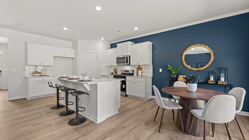 Interior kitchen with center island and white cabinets