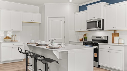 Interior kitchen with center island and white cabinets