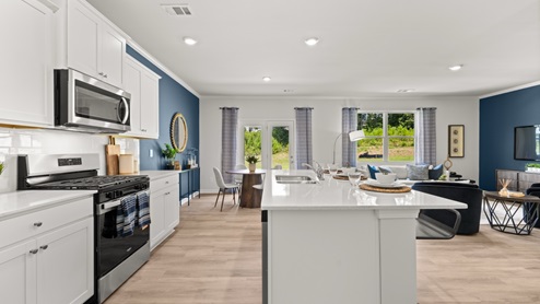 Interior kitchen with center island and white cabinets
