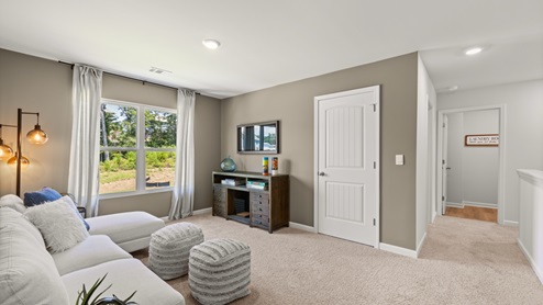 Interior upstairs loft area with large window and closet
