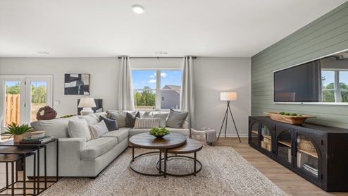 D.R. Horton’s Open Concept plan features family room connected to kitchen island, offering ideal setup for hosting, cooking, and gathering in one space with hardwood floors