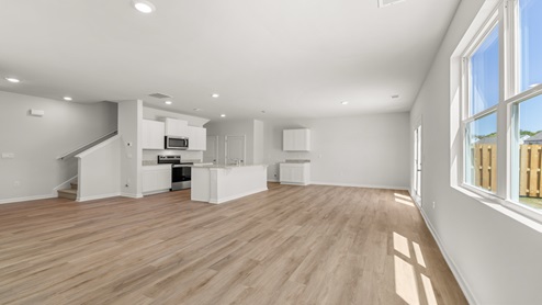open concept living area with the living room, kitchen and dining area all connected
