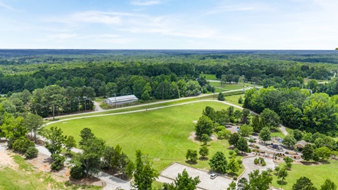 Aerial view of lush land near community.