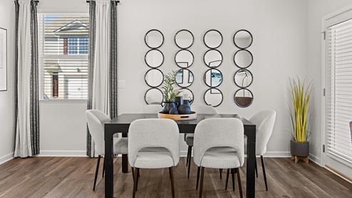 pearson model townhome dining area off of the kitchen and living room with hardwood-like flooring