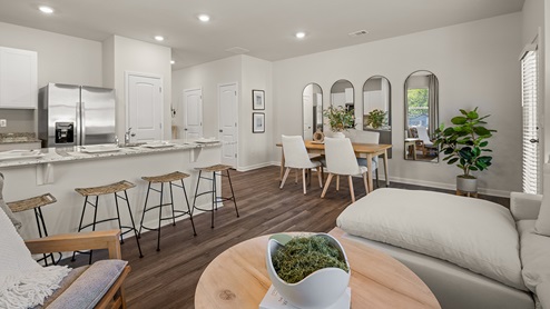 pearson open concept living room with hardwood flooring looking into the kitchen