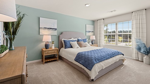 pearson townhome primary suite bedroom with a large window for natural lighting