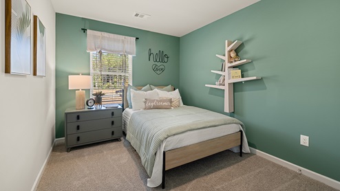 pearson secondary bedroom on the second level with a window and light carpet