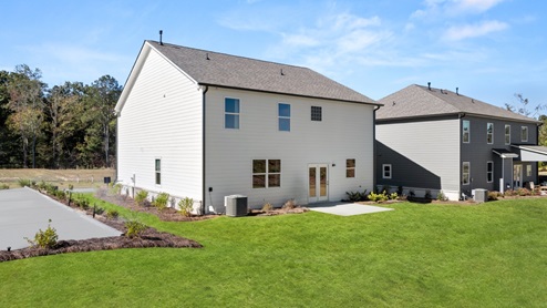 Exterior rear view of two-story home and back yard