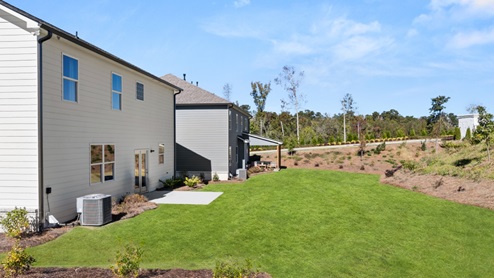 Exterior rear view of two-story home and back yard