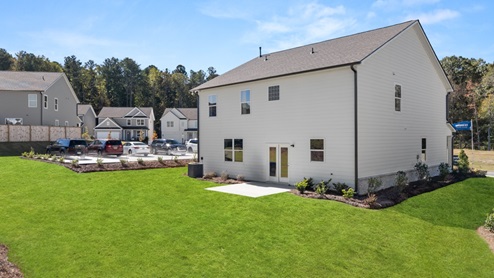 Exterior rear view of two-story home and back yard