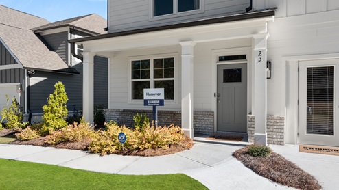 Exterior two-story home with cladding and stone detailing