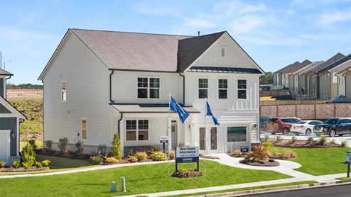 Exterior two-story home with cladding and stone detailing