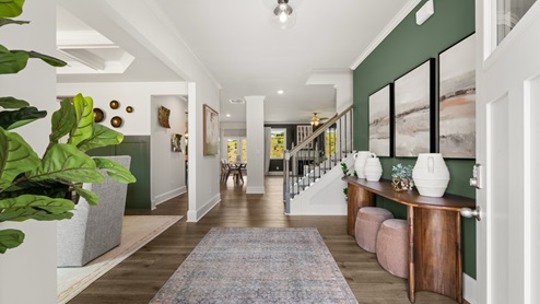 front entry way of home featuring brown flooring and white walls
