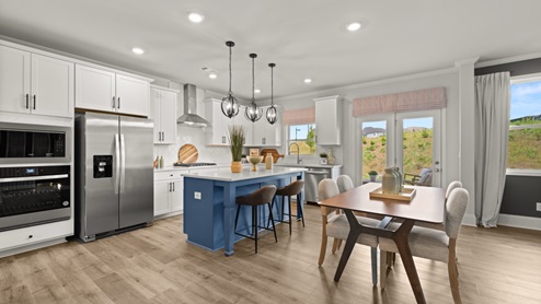 kitchen with white cabinetry, large island, and stainless steel appliances