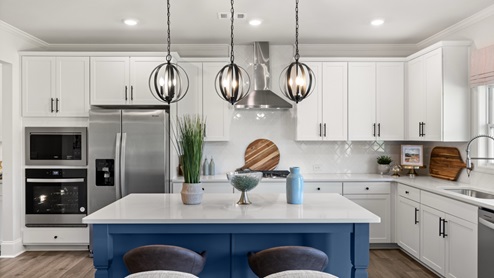 kitchen with white cabinetry, large island, and stainless steel appliances