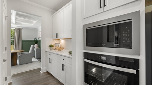 kitchen with white cabinetry, large island, and stainless steel appliances