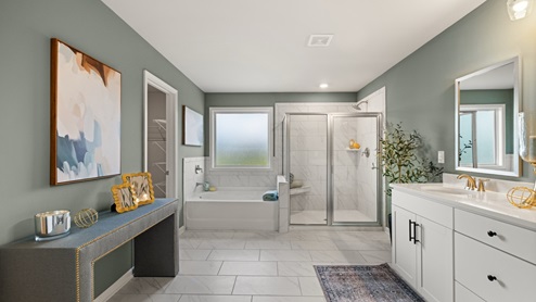 bathroom with dual vanity sinks, toilet, bath tub and a walk in shower
