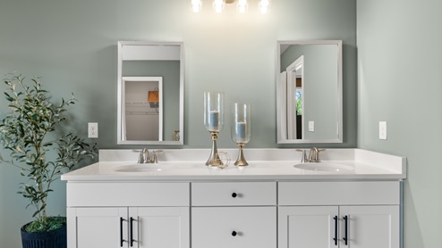 bathroom with dual vanity sinks, toilet, bath tub and a walk in shower