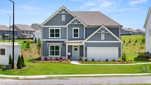 Two-story exterior home image with blue siding, white trim, and two-car garage.