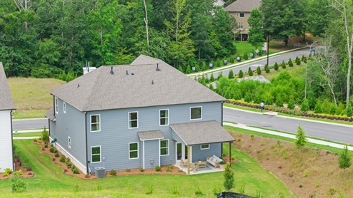 rear exterior of home featuring a spacious backyard