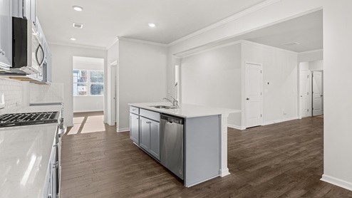 Interior kitchen with center island and light grey cabinets