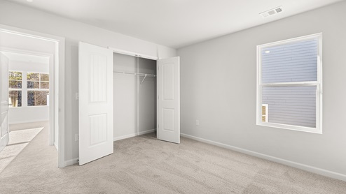 Interior bedroom with large window and closet