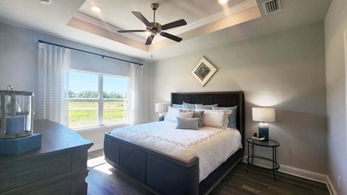 The primary bedroom of the Rhett floor plan model home.