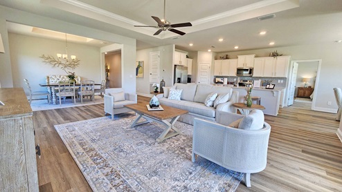 The living room and kitchen area of the Camden floor plan model home.