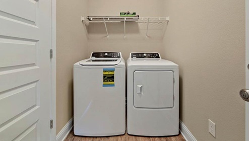 Laundry room with wire shelf.