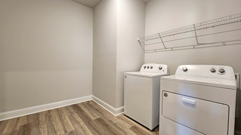 Laundry room with with wire shelving.