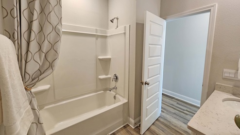 Guest bathroom with combination tub and shower.