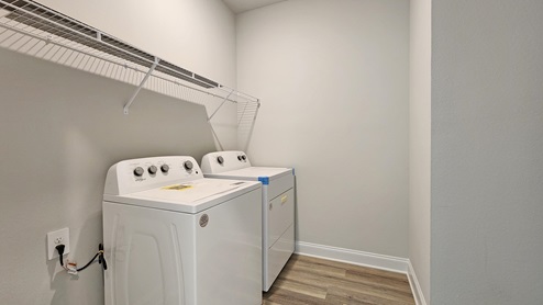 Laundry room with shelf.