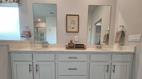Double sink vanity with granite countertop.