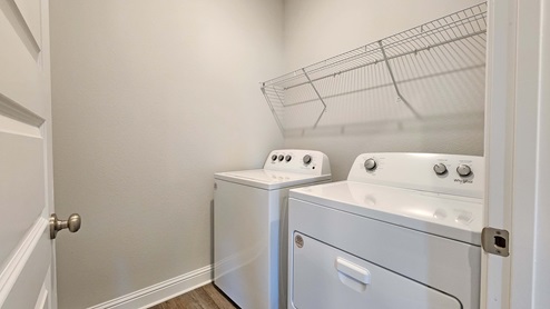 Laundry room with a shelf.