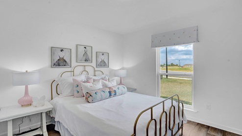 Secondary bedroom with one window overlooking the front yard.