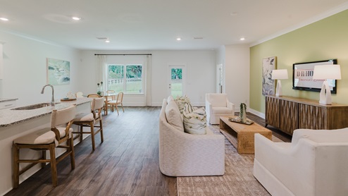 Open concept living area connecting the kitchen, living, and dining rooms.