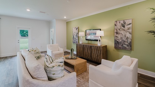 Spacious living room with back door leading to a covered porch.