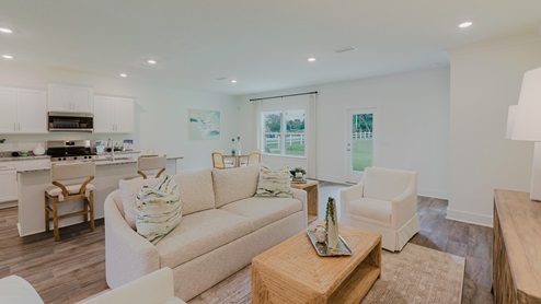 Spacious living room with back door leading to a covered porch.