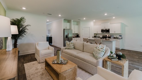 Spacious living room with back door leading to a covered porch.