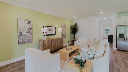 Spacious living room with back door leading to a covered porch.