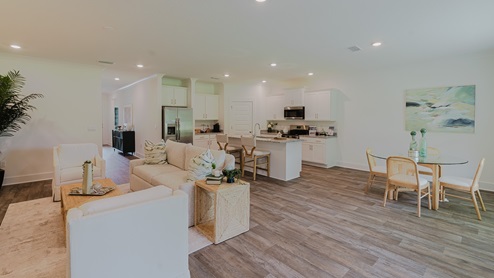 Open concept living area connecting the kitchen, living, and dining rooms.