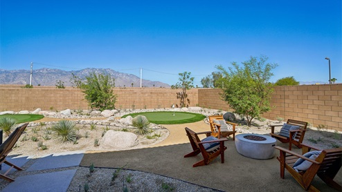 Spacious backyard with turf and firepit