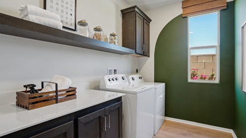 Laundry room with upper cabinets and washer and dryer