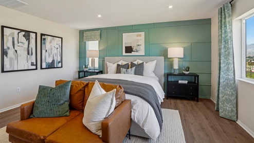 Primary bedroom with king bed and laminate flooring