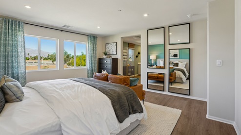 Primary bedroom with king bed and laminate flooring