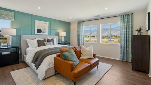 Primary bedroom with king bed and laminate flooring
