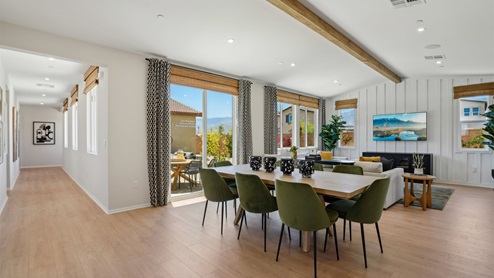 Spacious open-concept great room and dining room with vaulted ceiling