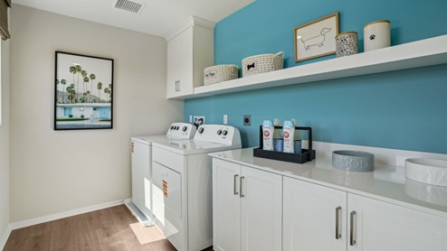 Laundry room with upper cabinet, shelf and washer and dryer