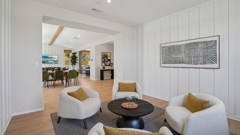 Spacious open-concept great room and dining room with vaulted ceiling